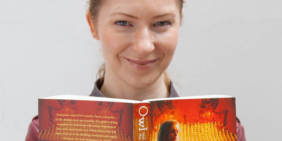 Headshot of Kristi Charish holding her book.