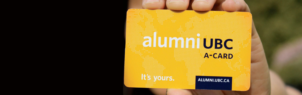 Hand holding a UBC alumni card in view