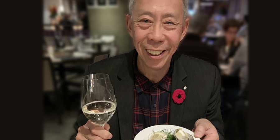 Howard Soon holding a glass of Sauvignon Blanc. 