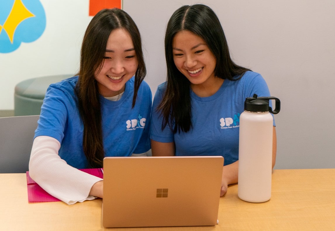 Two SPAC leaders looking at a laptop