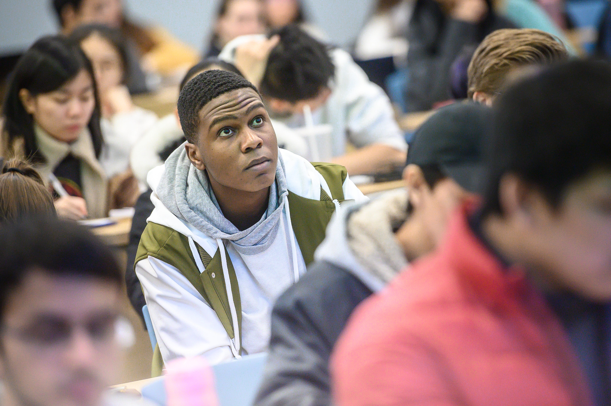 A student looks up towards an offscreen lecturer.