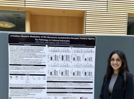Alaana Shamji in front of a presentation board