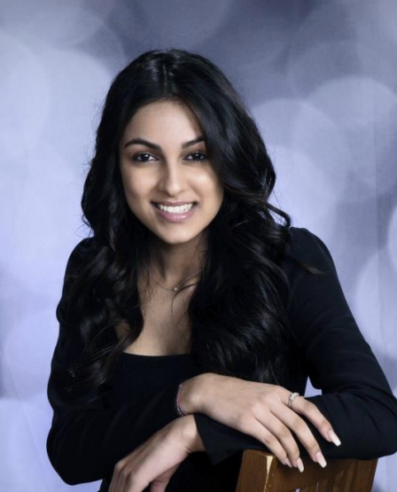 Alaana Shamji has long black hair and wears a black top
