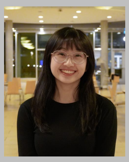 Charlotte Lee wears a black shirt and glasses