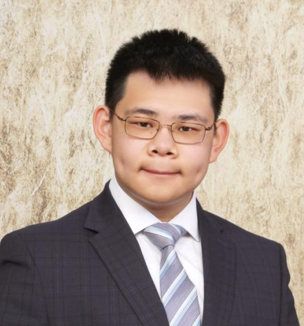 Karl Tsang wears glasses and a striped tie