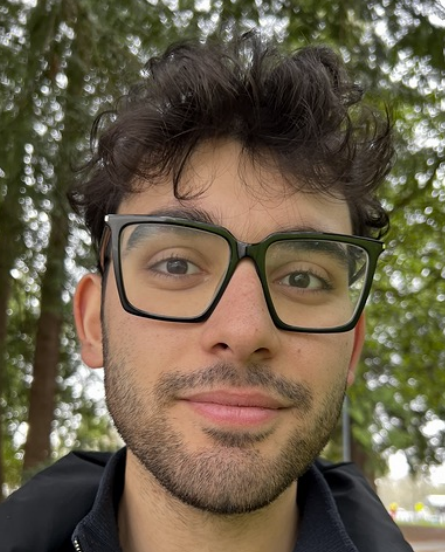 Radman Rakhshandehroo wears black glasses and has black hair