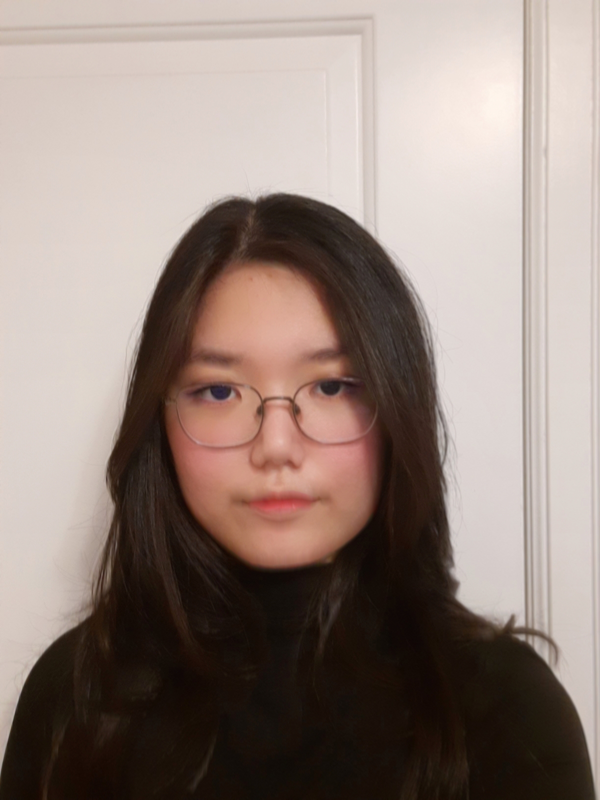 Thea Do wears a black turtleneck and has long brown hair