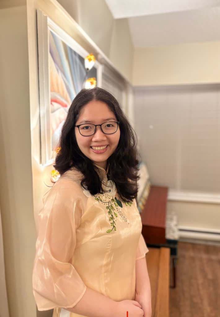Vicky Nguyen wears black glasses and a cream top