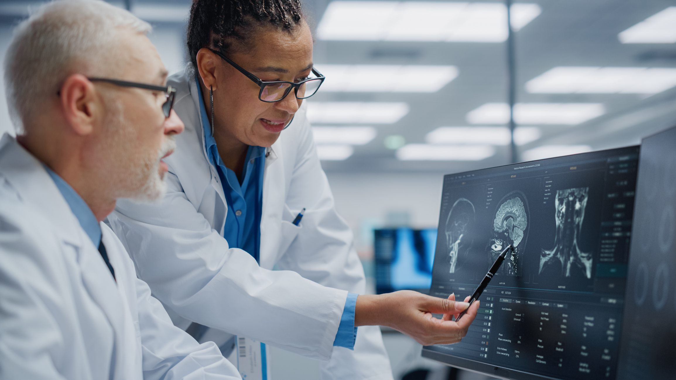 Technicians reviewing a brain scan