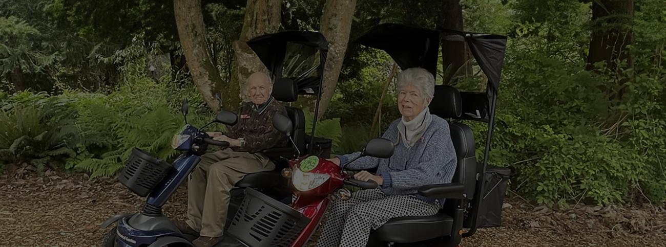 Margaret and Charlie sitting on scooters