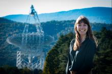 Dr. Ilsa Cooke stands in front of the Green Bank Telescope.