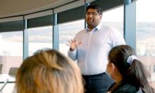 Dr. Firas Moosvi lecturing in a classroom.