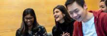 Three students smiling